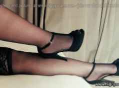 Putting on her sexy high heels shoes and stockings slowly...